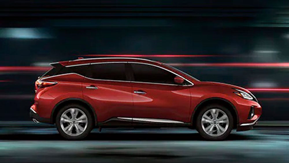 2023 Nissan Murano shown in profile driving down a street at night illustrating performance. | Rydell Nissan of Grand Forks in Grand Forks ND