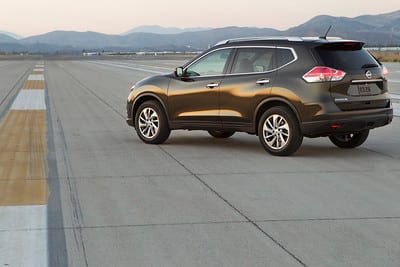 Nissan Rogue parked on test track with mountains in background