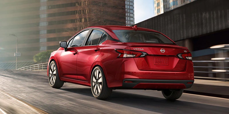 2021 Red Nissan Versa Driving on a road