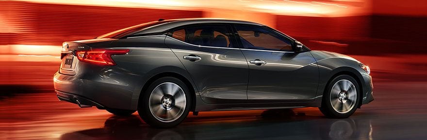 Nissan Maxima in front of a sun set